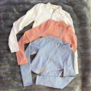 Set of Three Zip-Up Jackets in White, Peach, and Light Blue